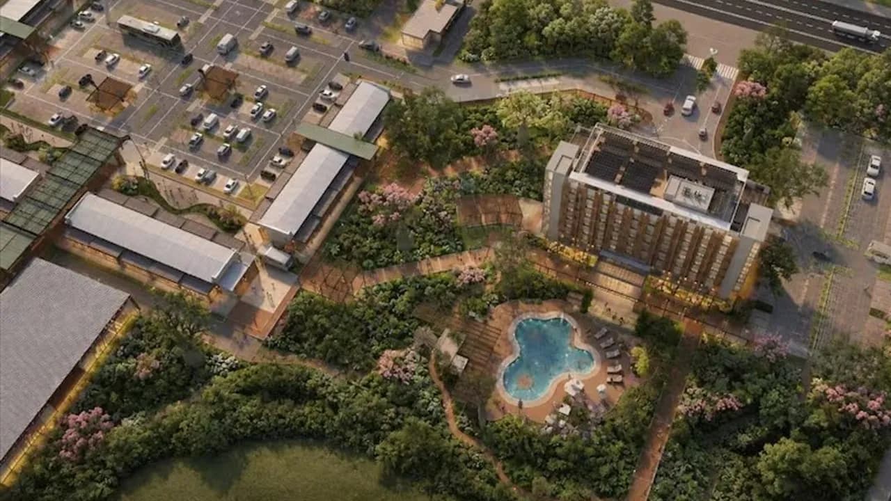 Representación digital de un complejo urbano en el Chaco con piscina central, hotel, edificios y estacionamientos.