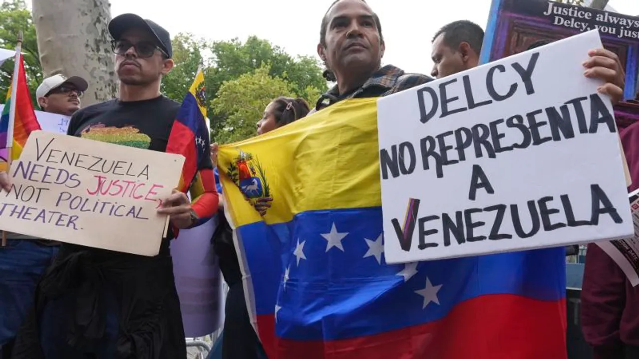 Manifestantes sostienen una bandera de Venezuela y carteles de protesta escritos a mano en una calle urbana.