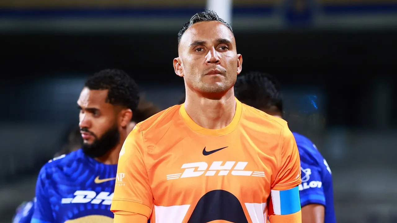 Keylor Navas con indumentaria de arquero color naranja durante un calentamiento previo en el estadio.