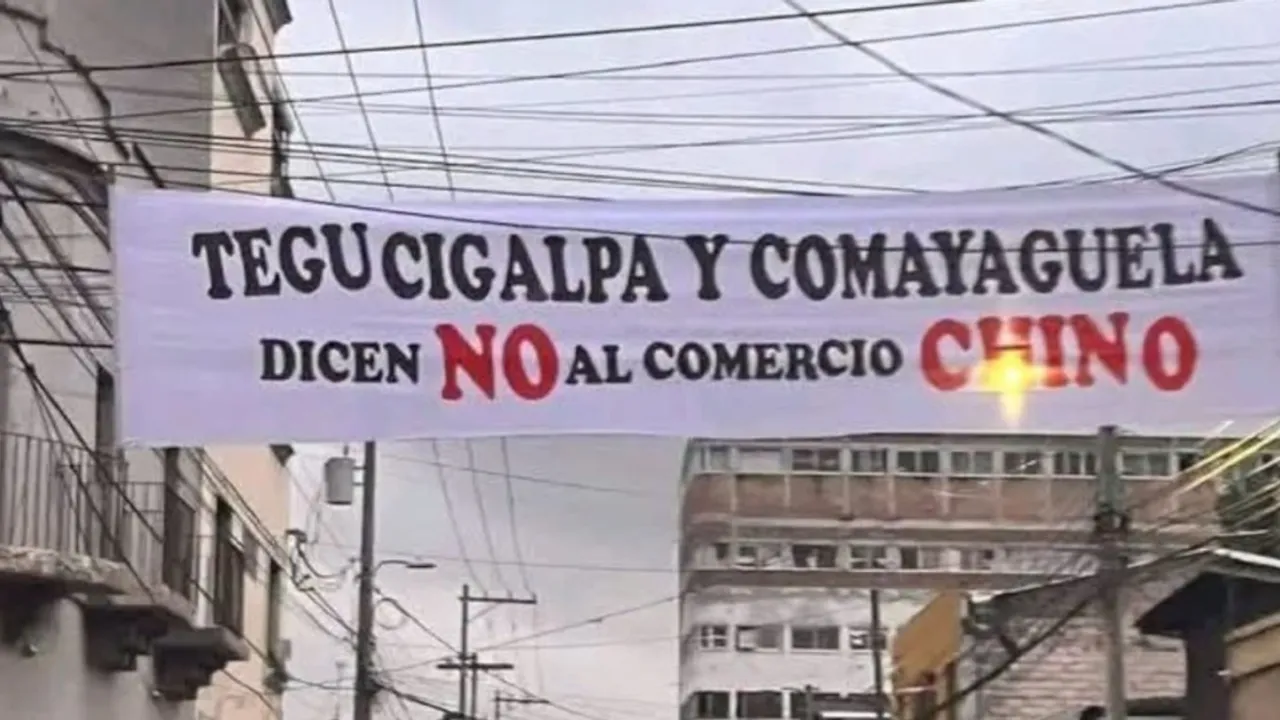 Pasacalles colgado en una calle urbana con una frase en rechazo a las tiendas comerciales chinas.